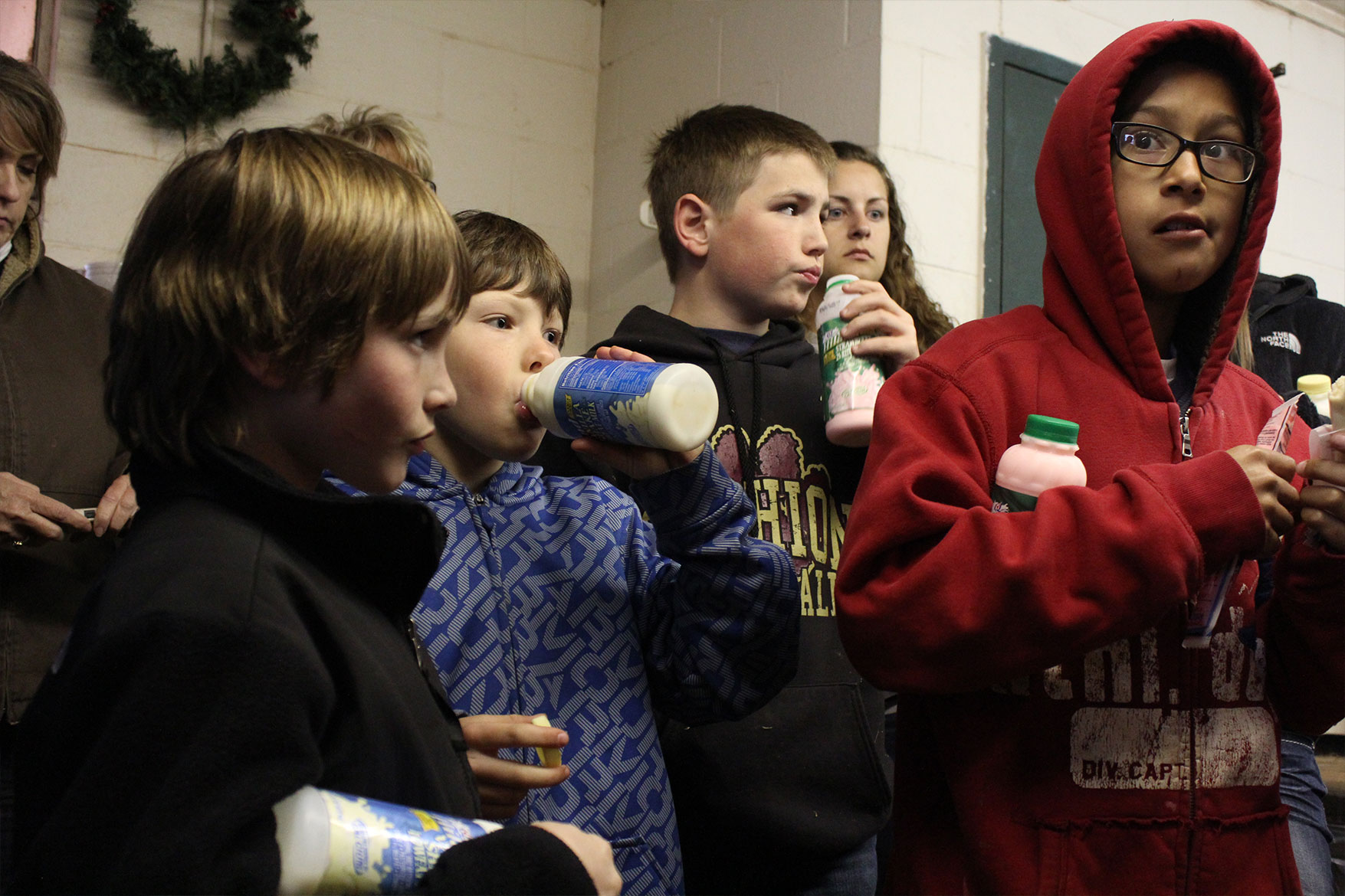 A group of students enjoying milk while touring M6 Dairy.