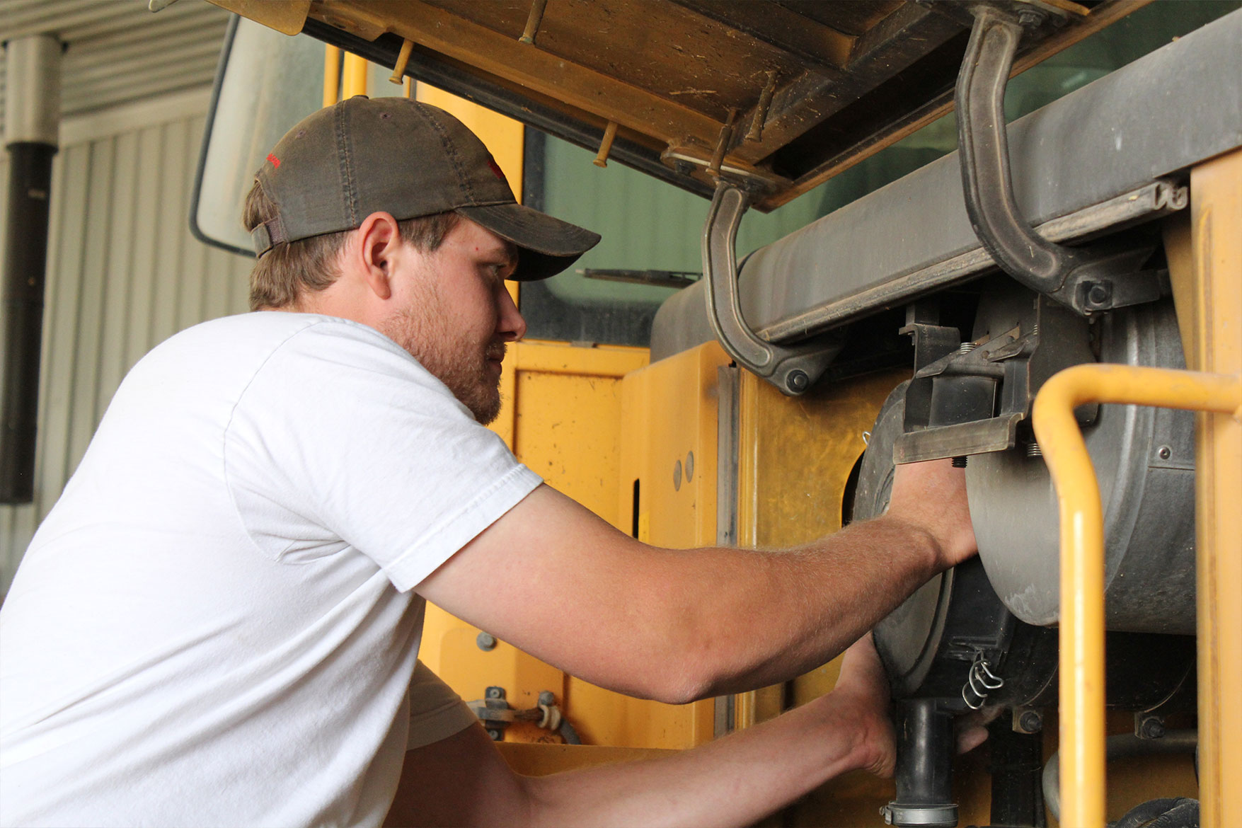 Working on farm equipment at Mid Frisian Dairy farm.