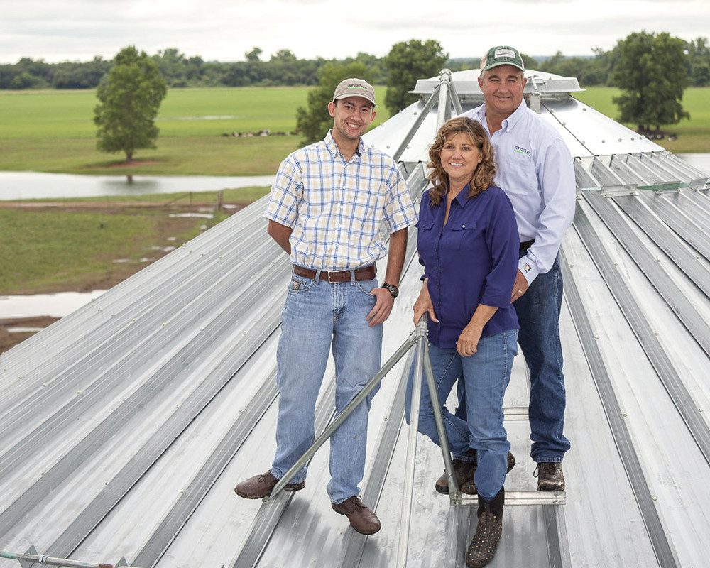 The Jackson family poses on top of their silo.