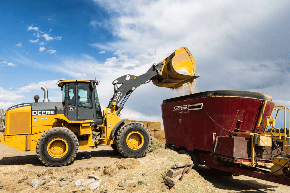 Feed ingredients being loaded into the feed truck for mixing and eating.