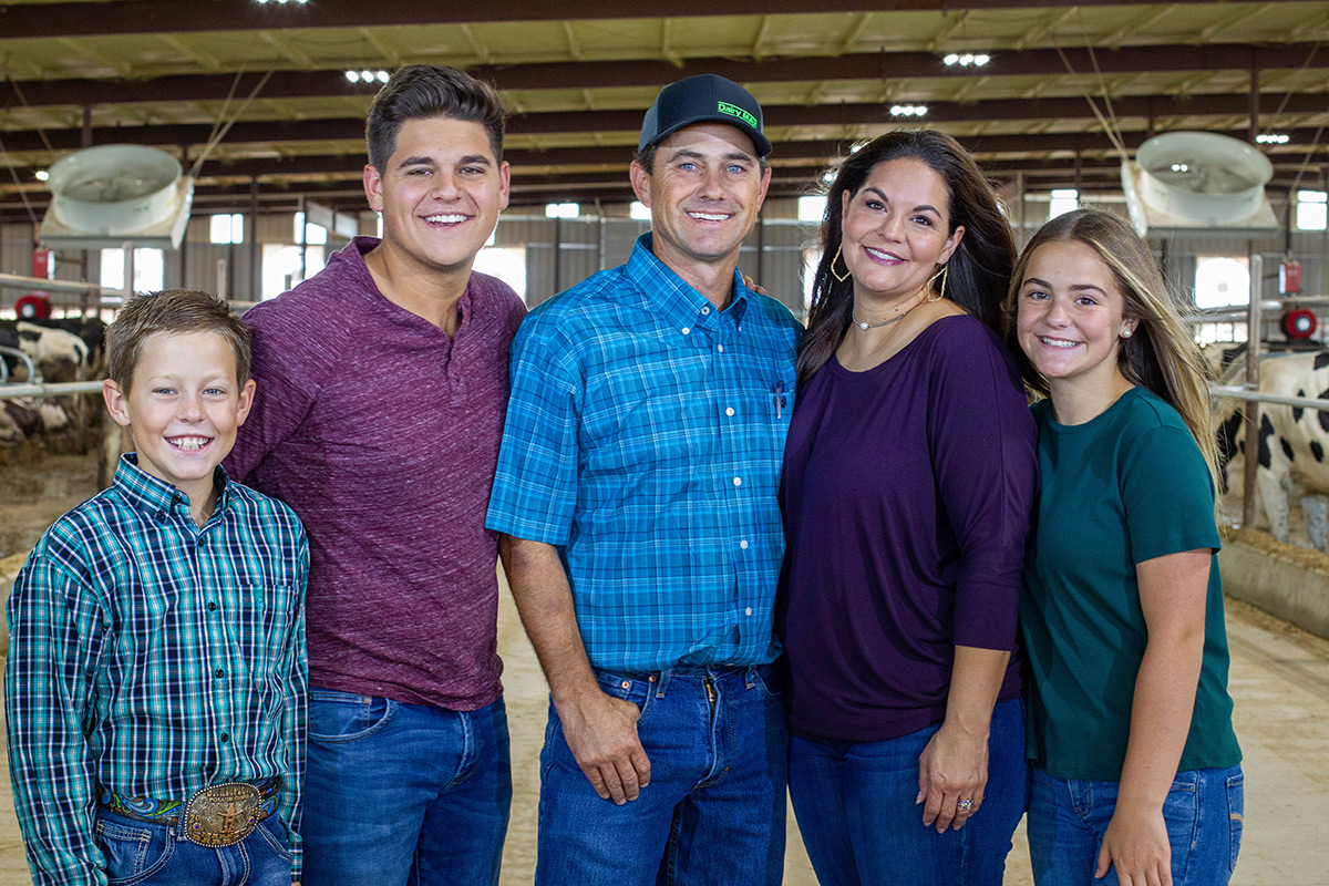 The Collier family poses for a photo in their barn.